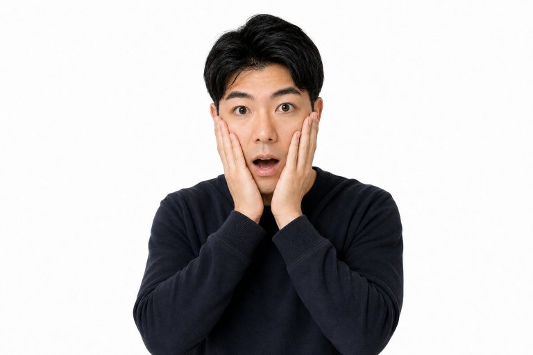 頬に手を当てて驚く男性(白背景)
