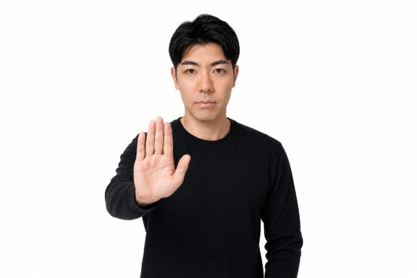 手を前に出して制止する男性(白背景)