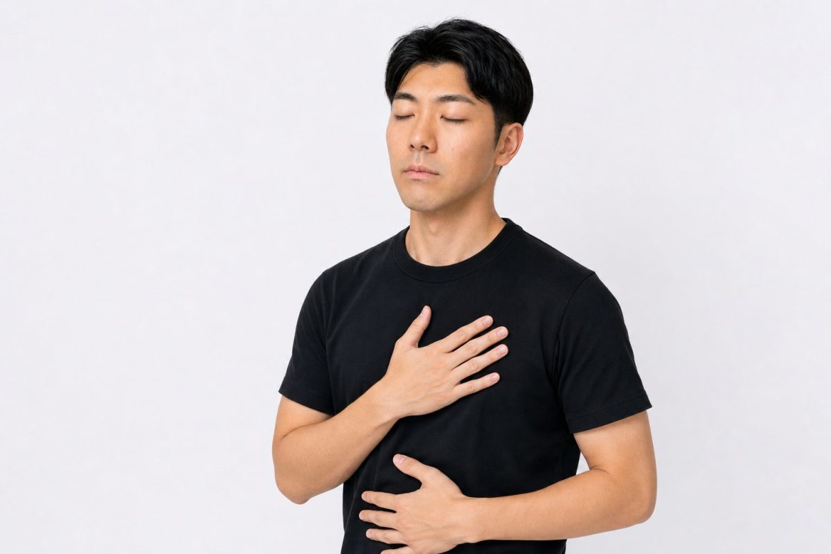 深呼吸して落ち着く男性(白背景)