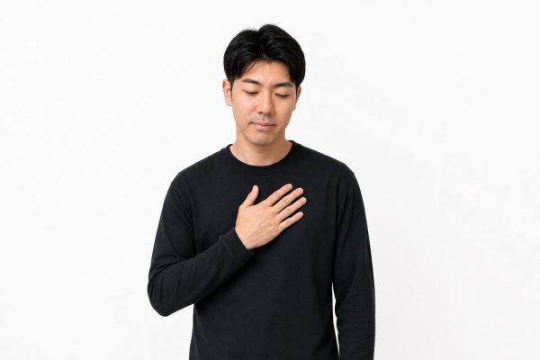 ほっと胸をなで下ろす男性(白背景)