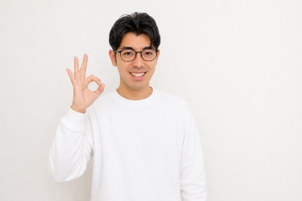 明るくOKサインを出す男性(白背景)